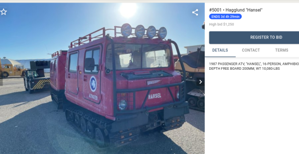 Bright red, tracked Arctic Exploration vehicle which is parked down the street, in Ventura County, up for auction (3 d 4 h left). The vehicle has the Antarctica Expedition symbol on the side and the name "Hansel" on front, and has lights along the top.