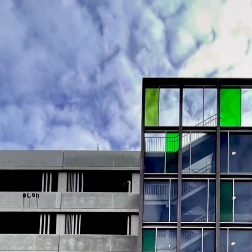 Parking garage with a stairwell adorned with seemingly random panes of decorative green glass