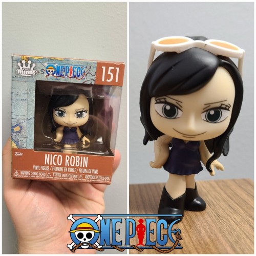 Collage of two photographs stacked left to right. The left figure is a boxed Funko Minis figure (One Piece 151, Nico Robin). The box has the figure shown in the center with the One Piece logo in the center, top of the box. The box is being held against a light grey wall by a white person's hand. The right image shows the figure out of the box. It is Nico Robin from One Piece in her Dressrosa outfit. In the Funko Mini style with an oversized head, the figurine has a dark hared, light skinned, light colored eyed feminine figurine wearing long black boots, a dark blue strapped dress, and white sunglasses on her head worn like a headband.