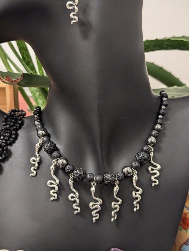 handmade shimmering black, hematite styled bead and lots of silver snake pendants