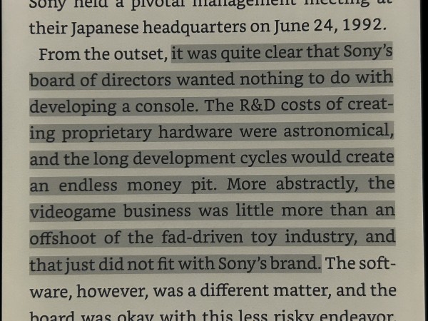 Text from a book discussing Sony's pivotal management meeting in 1992 and the company's initial reluctance to develop a gaming console due to high R&D costs and long development cycles.