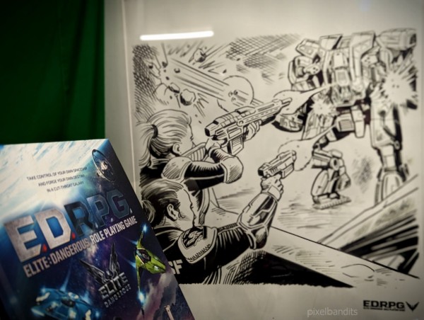 The Elite role-playing book in front of a large black and white comic book frame showing two security guards (bottom left) firing at a military mech (top right)