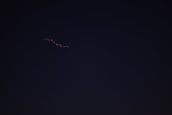 Photo of a plane in the night sky.