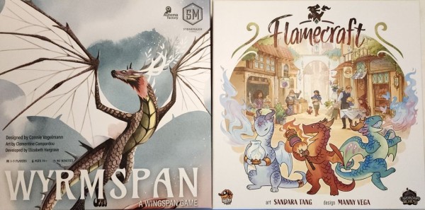 The box covers of two tabletop games. Wyrmspan, with a dragon in flight in front of clouds (or a fog-shrouded hill), and Flamecraft, with a trio of dragon crafters crafting with a set of village shops in the background.
