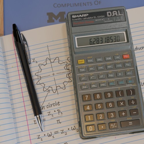 3D Render of Sharp DAL calculator with pen, on top of university blue book exam booklets—top view