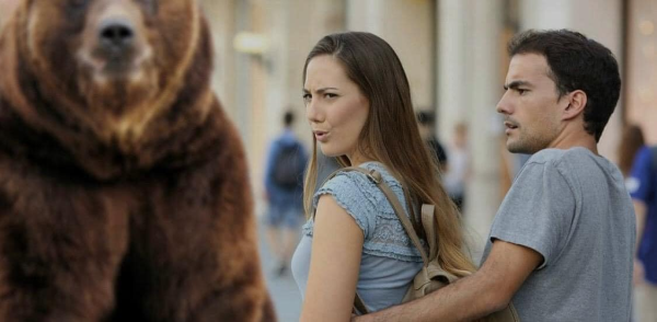 The "woman looks at someone walking by as her male partner looks upset" meme but the person walking by is a standing grizzly bear