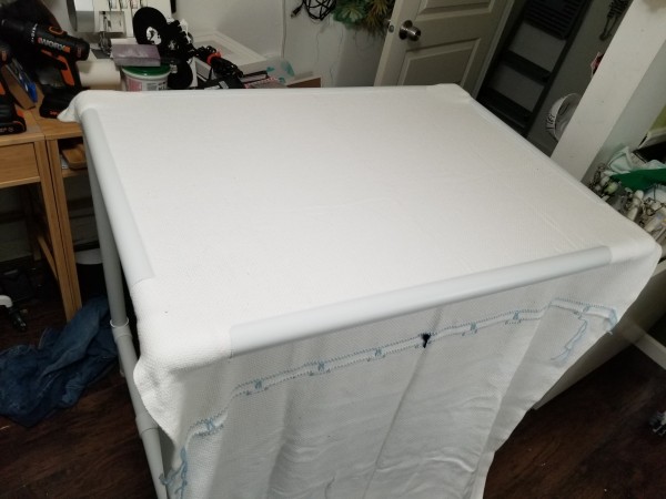 white cloth stretched on a pvc quilt frame. good tension on the fabric, but hoo boy it takes up my whole room