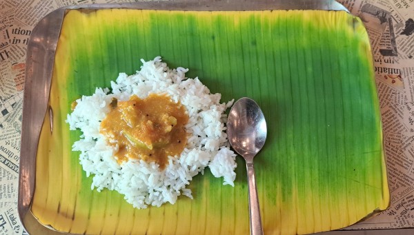 Sambhar rice on banana leaf for lunch today.