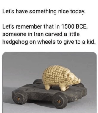 A photo of an ivory-coloured, carved hedgehog standing on flat cart with small wheels. Caption: "Let's have something nice today. Let's remember that in 1500 BCE, someone in Iran carved a little hedgehog on wheels to give to a kid."