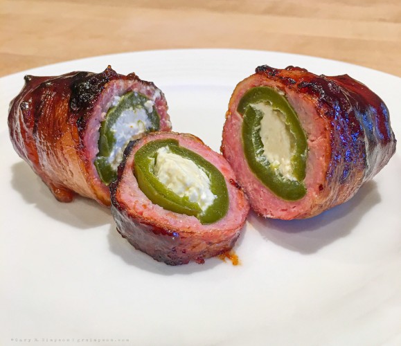 Armadillo Egg - cream cheese stuffed jalapeno covered with ground pork, wrapped in bacon, coated with barbecue sauce, and smoked for 2 hours.