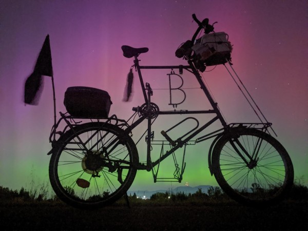 Tall bike behind the northern lights