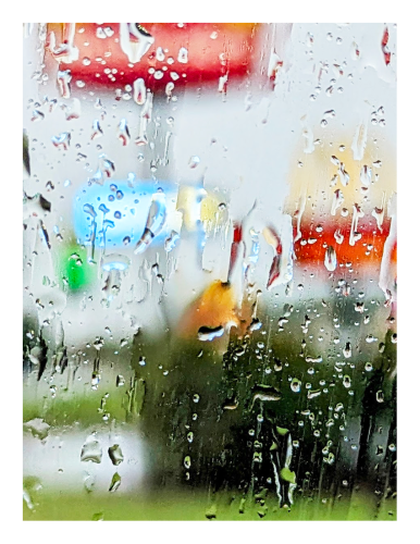 view through rain-smeared car window of the entrance to mcdonalds