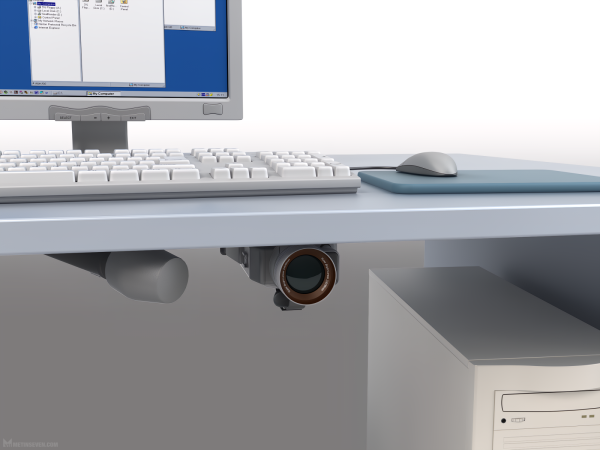 Realistic 3D illustration, showing a desk with a desktop PC setup. Hidden underneath the desk are a camera and microphone.