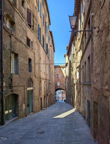 Light and shade. Via Fontebranda at Siena, Tuscany, Italy. April 2024.