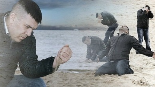 Man grieving on beach