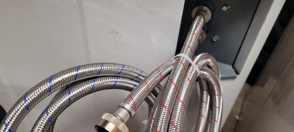 Two new braided hoses on a washing machine