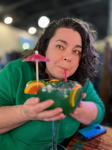 Me, sipping a fancy blue green Hawaiian margarita with lots of fruit and a paper umbrella, it is huge!