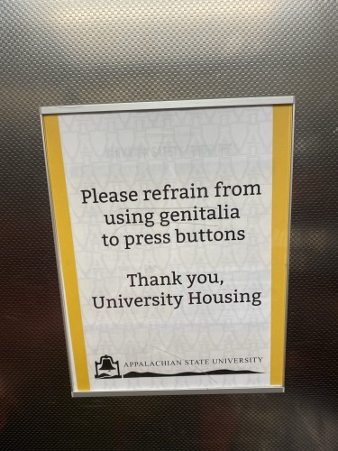 Prank sign posted in university dorm elevator that reads, “Please refrain from using genitals to press buttons.”