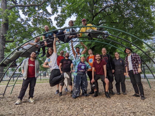 A photo of a group of 15 Godot enthusiasts who joined yesterday's meetup at the Max-Josef-Metzger-Platz park in Berlin. Most are standing under a climbing scaffolding for kids, while four brave ones actually climbed on top of it.