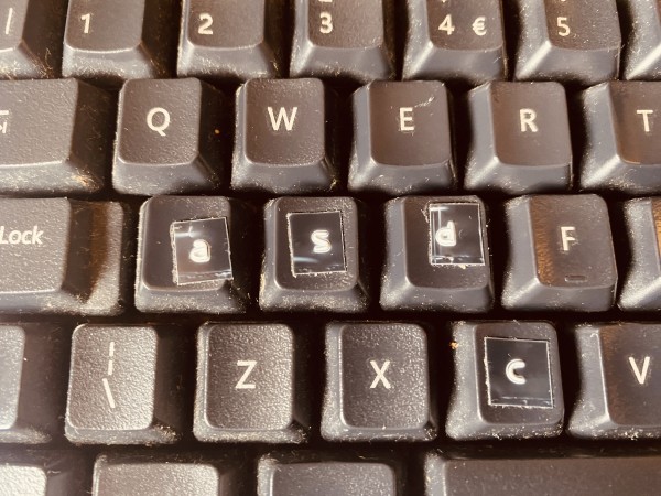 A keyboard with some diy labels on the keys.