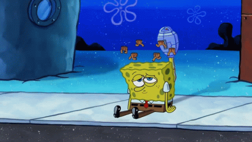 Spongebob sitting on a sidewalk, dizzy