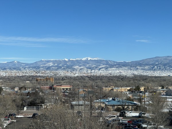 View of Espanola, NM with snow capped mountains in the background.