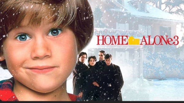Promotional image for "Home Alone 3" featuring a close-up of a young boy in the foreground and four adults in the background, with a snowy house scene and the movie title text.