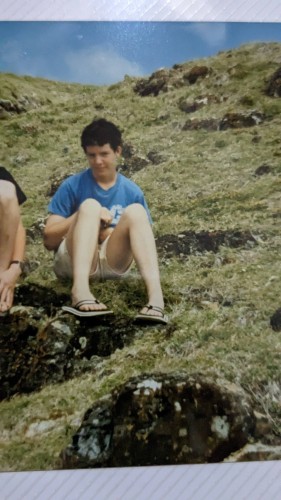 Me as a teenager, sitting on a rock a bit like a sissy 