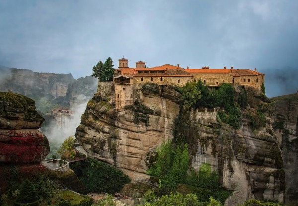 Ethereal Meteora landscape is highlighted by the monastery that is perched high above the clouds below. 