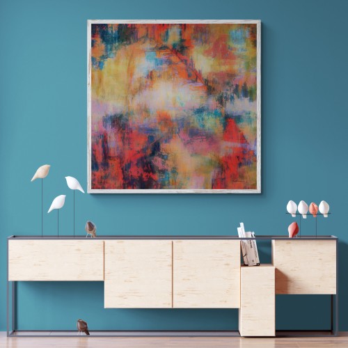 A work of art titled Number Six-Twenty-Four is shown framed and hanging on a wall in a modern-decor setting. The art comprises splashes of brilliant vermillion and scarlet reds offset by more muted golds, teals, blues, and orange. 