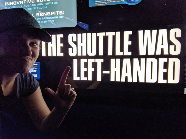 Me standing in front of a sign at the Kennedy Space Center making a face and an "L" with my hand

The sign reads: "The shuttle was left-handed."