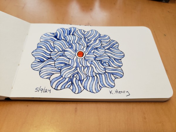 Hand drawn generative art in ink on an open page of my sketchbook. The abstract pattern is floral.