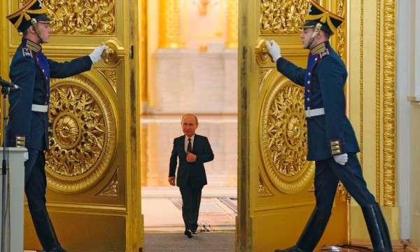 Putin walking through golden doors