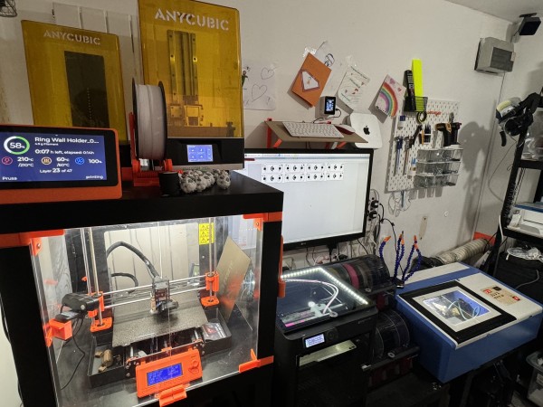 A collections of 3D printers, laser cutter and assorted hardware and accessories. All then equipment is powered on and busy. 