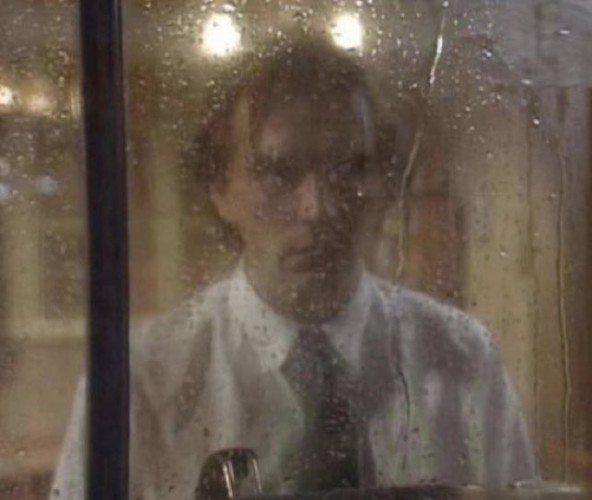 Richie from Bottom staring morosely out of a window, watching the rain.