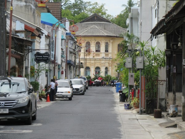 the view down a quiet side street towards a large colonial-era building