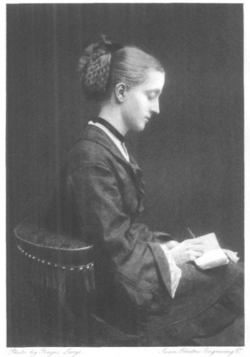 Juliana Horatia Ewing

Portrait of a woman sitting sideways, with her hair in a bun at the back of her head, wearing a black dress with lace on the sleeves and on her sill, with a pendant around her neck and apparently writing something in her notebook.